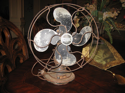 Rusty Emerson antique fan before restoration with weathered blades, cage and base.