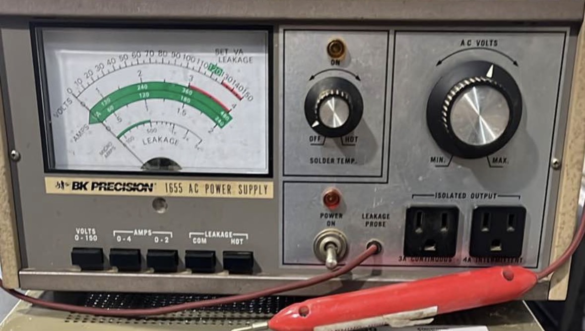 Winding bench with copper wire, stator and open technical notebook.